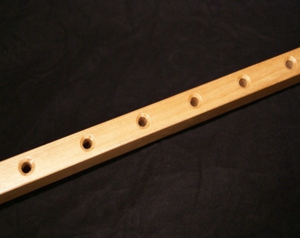 Custom wood mouldings and dimension stock made into wooden hammock bars with cross bore holes countersunk on both sides, available in bulk.